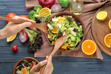 Sticker - Woman mixing kale salad on table