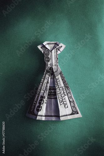 An Origami Dress Made From Hundred Us Dollar Bill On Green