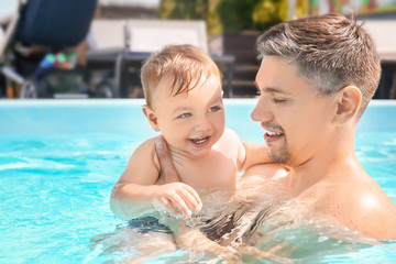 Poster - Child swimming lesson. Cute little boy with father in pool