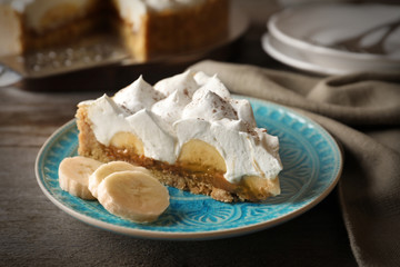 Wall Mural - Plate with piece of delicious banana cake on table