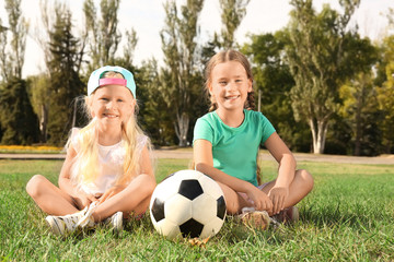 Wall Mural - Cute children with soccer ball on lawn