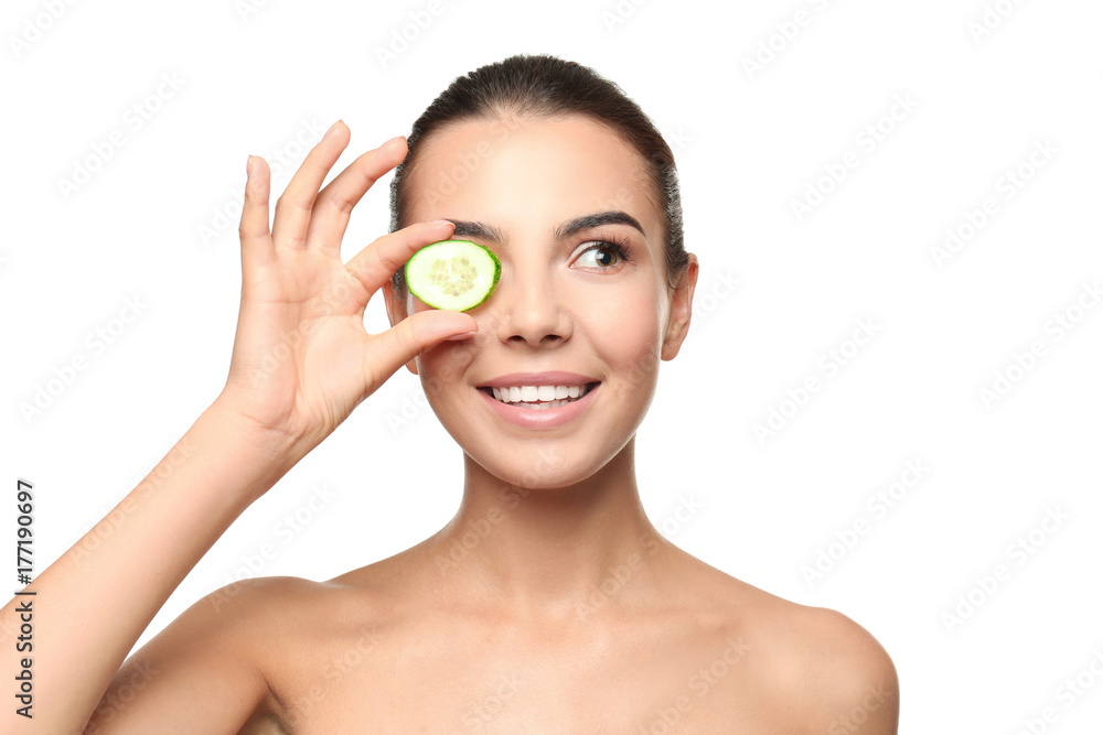 Young woman with cucumber slice on white background