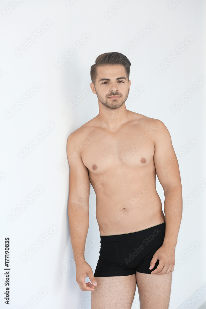 Sexy man in underwear on white background