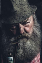 Portrait Of An Angry Looking Full Bearded Old Man With A Pipe And A Millinery