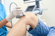 © Africa Studio - Doctor conducting ultrasound examination of patient's knee in clinic