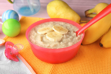 Poster - Plastic bowl with porridge for baby on fabric