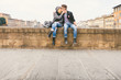 © Giorgio Magini/Stocksy - Teenage Couple Kissing by the River in the Old City