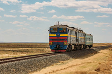 Locomotive Train Is Passing Through Kazakhstan Desert