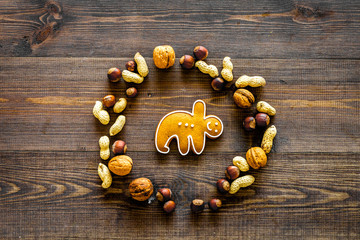 Healthy food for sportsman. Yoga asanas cookie in nuts' round on dark wooden background top view copyspace