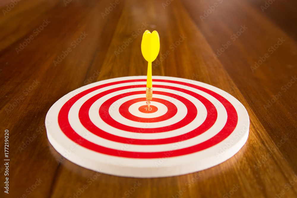 Warm tone of Circular target marked with numbers and dart. An idea of ...