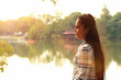 © toodtuphoto - holiday with warm sunshine in morning time,pretty girl in wearing a plaid shirt,woman smile and relaxing happiness standing beside pond in park