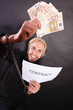 © anetlanda - Man with chained hands holding contract and money