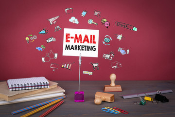 Wall Mural - Email Marketing concept. Wooden table at the red background.