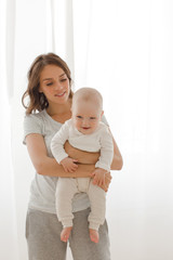 Wall Mural - Woman playing with infant child