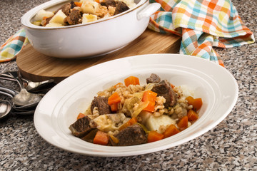 Wall Mural - served irish beef and barley stew in a deep plate