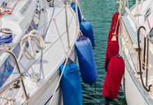 Two Boats Anchored At The  Harbor /detail Of Two Boats Anchored With The Typical Colored Fenders