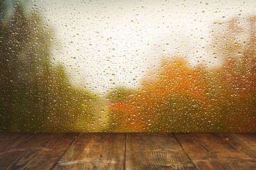 Wall Mural - Table on rainy window background