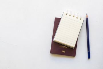 Notepad with passport and smartphone on wood board background.using wallpaper for education, business photo.Take note of the product for book with paper and concept, object or copy space.