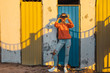 © tinyakov - Young Girl Stands Near A Colorful Wall And Looks Through Binoculars