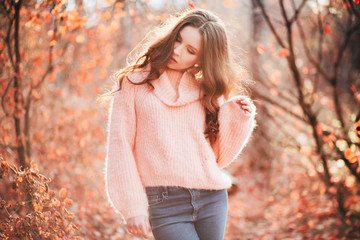 Young sexy woman in the autumn forest