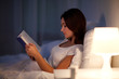 © Syda Productions - young woman reading book in bed at night home