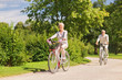 © Syda Productions - happy senior couple riding bicycles at summer park