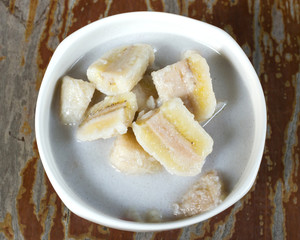 Wall Mural - Banana in Coconut Milk. Thai dessert. Banana sliced boil in coconut milk with sugar. Sweet taste and Hi nutritiion. Top view.