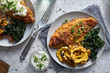 panfried catfish dinner with squash and spinach in flat lay compositon