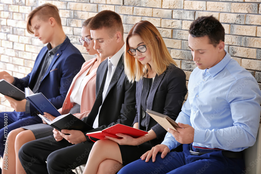 Group of people waiting for job interview on chairs