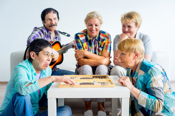 Senior people playing board games