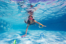 Girl Exercising During Underwater Swimming Lesson