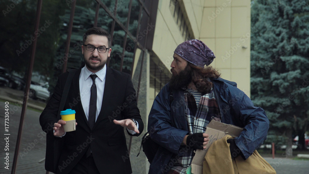 Rich Homeless Rich man weared in suit with coffee walking on street and talking to ...