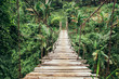© Jovo Jovanovic/Stocksy - Wide shot of wooden rope hung bridge in the jungle