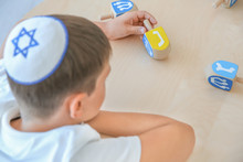 Jewish Boy Playing With Dreidel At Home