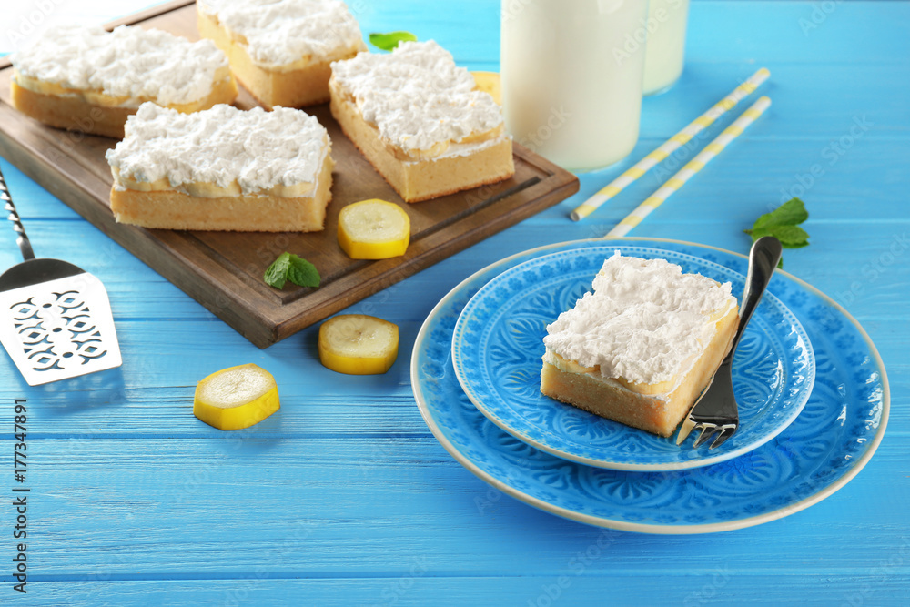 Composition with tasty banana cake on color wooden background