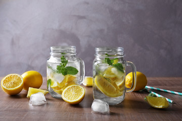 Canvas Print - Mason jars with mojito cocktail on wooden table