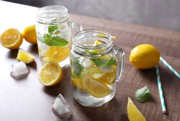 Wall Mural - Mason jars with mojito cocktail on wooden table