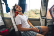 © AlejandroMCB photo & film/Stocksy - Young man traveling on a bus while backpacking