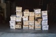 © Lucas Saugen Photography/Stocksy - Stacked cardboard boxes filled with of documents sitting in a garage.