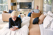 © Trinette Reed/Stocksy - Couple relaxing in luxury bedroom at home with technology