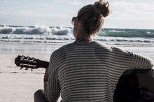 Playing Guitar On The Beach