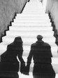 © Wave/Stocksy - Young couple shadow on the stairs