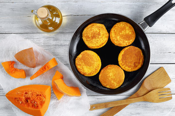 Wall Mural - pumpkin pancakes on skillet, top view