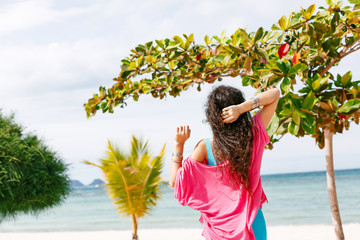 Wall Mural - boho styled young woman walking on the beach