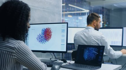 Fototapete - Multi-Ethnic Team of Computer Scientists Create Neural Network at Their Workstation. Office is Full of Displays Showing 3D Representations of Neural Networks.