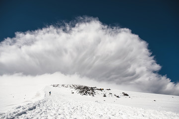 Stormy clouds overhang over the snow-capped mountain Elbrus