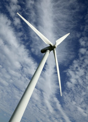 Wind turbine against blue sky and clouds