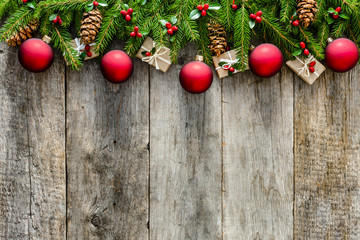 Wall Mural - Wooden background with christmas decorations on branches of green fir, frame or christmas card