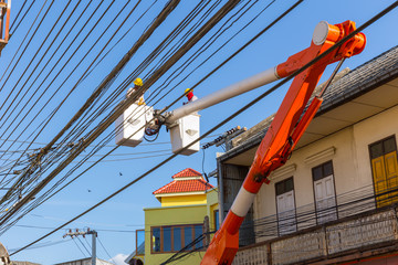 lineman duty working fix power line on electrical cable with aerial work platforms