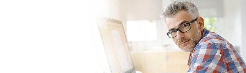 Web designer working in office on desktop computer- template